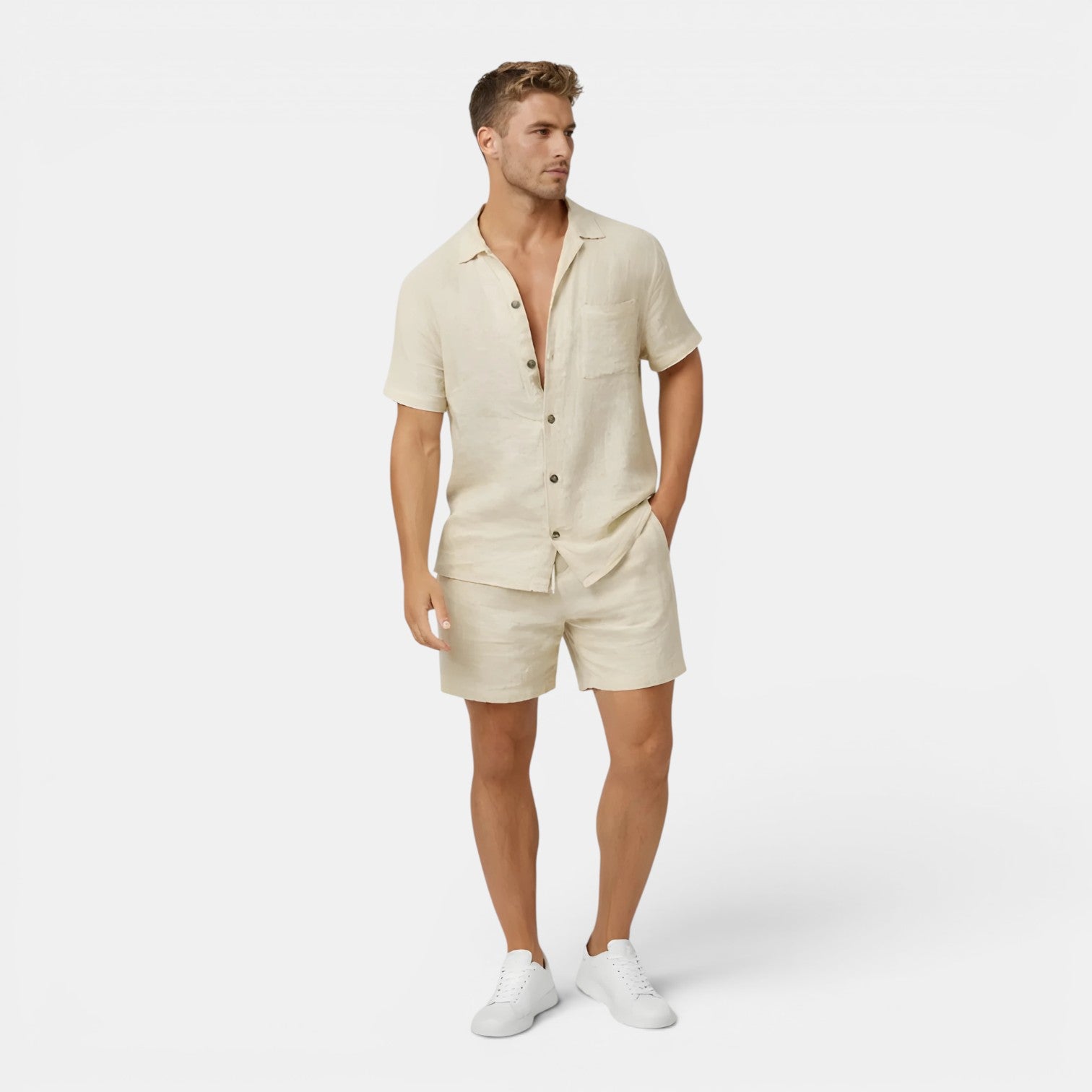 Man wearing a beige button-up shirt and shorts set on a white background