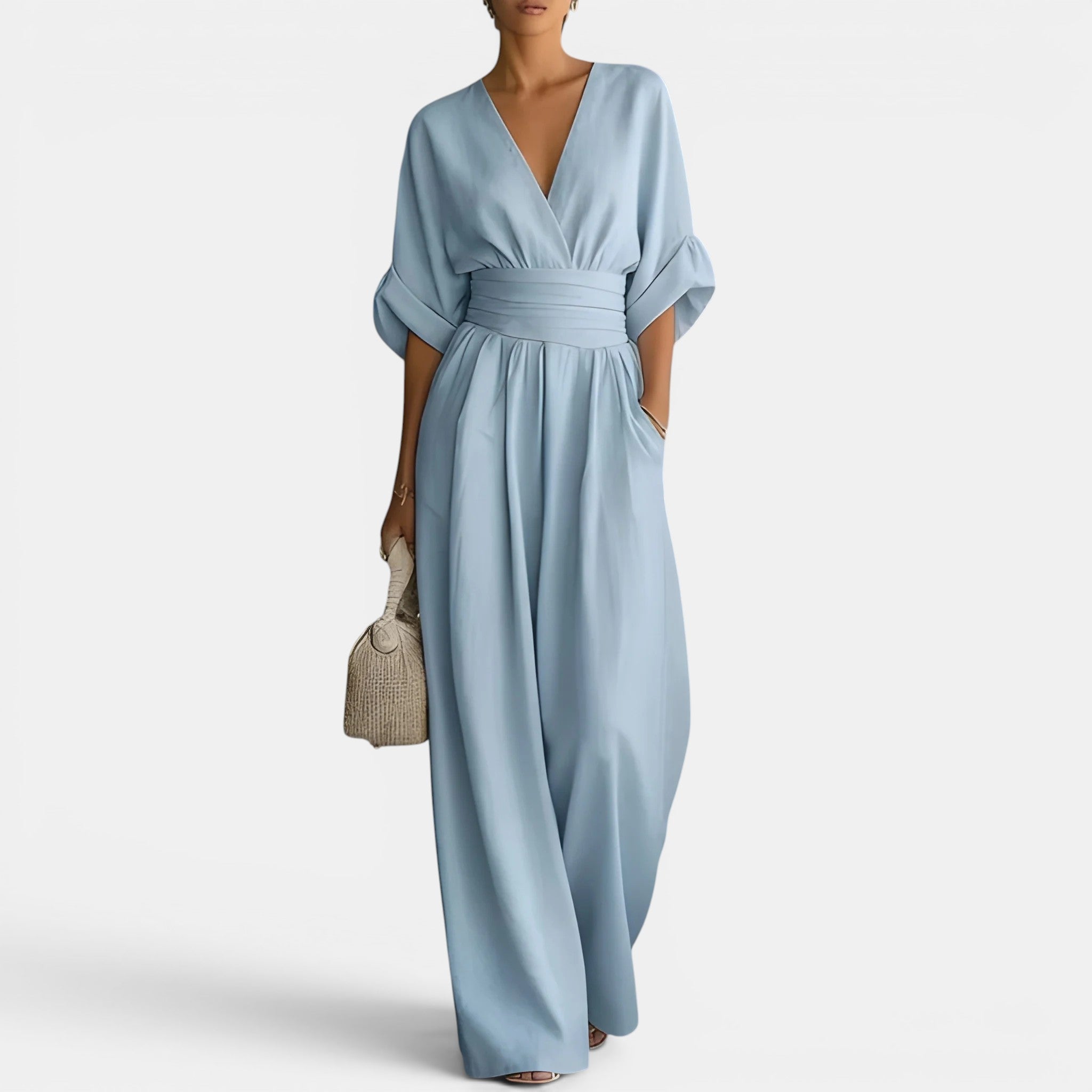 Light blue jumpsuit worn by a person on a white background
