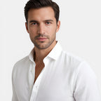 Man wearing a white shirt against a plain background