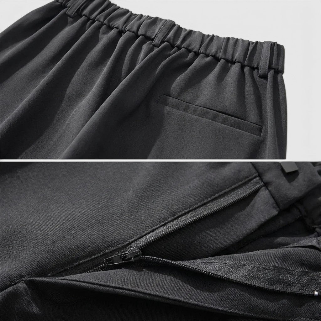 Close-up of black pants with an elastic waistband and zipper detail.