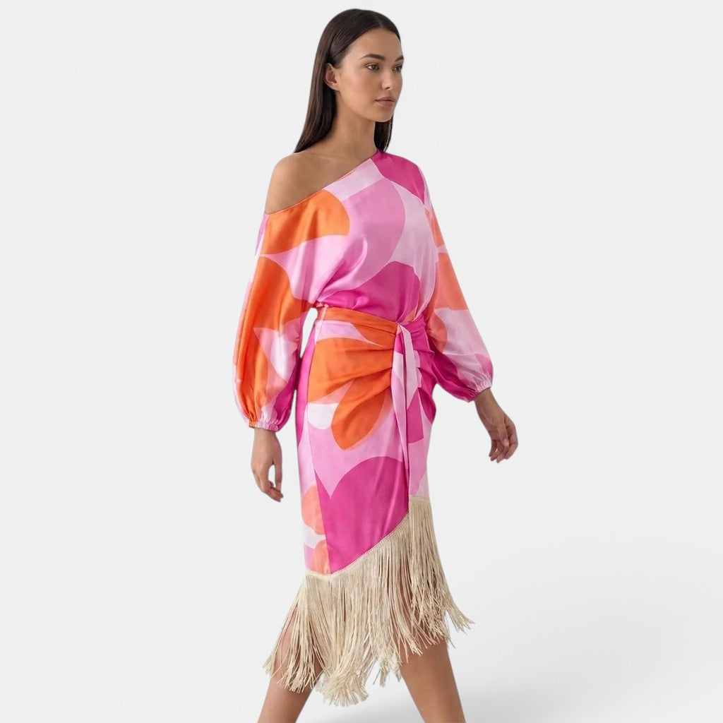 Woman wearing a colorful dress with fringes on a white background