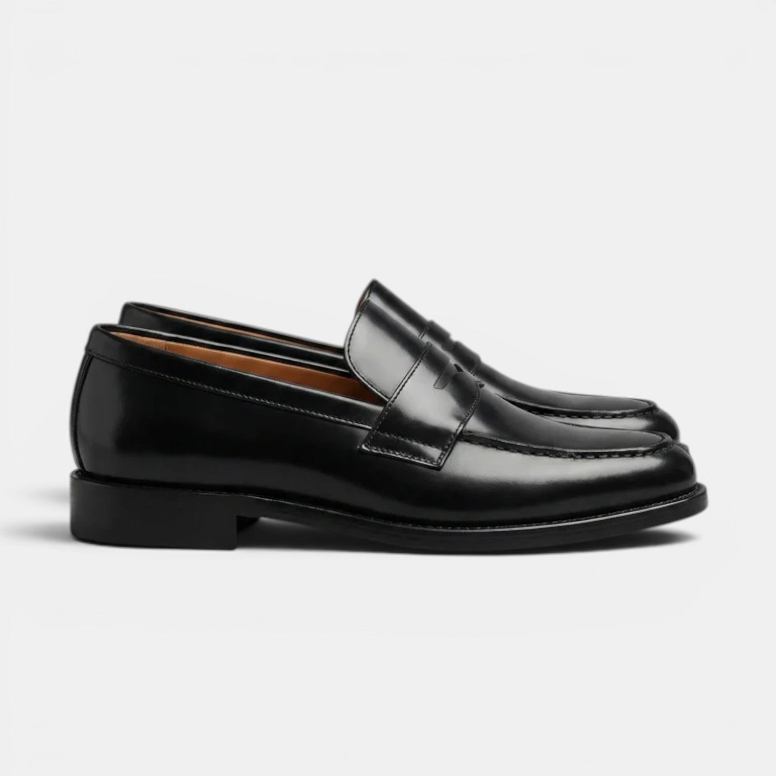 Pair of black loafers on a light gray background