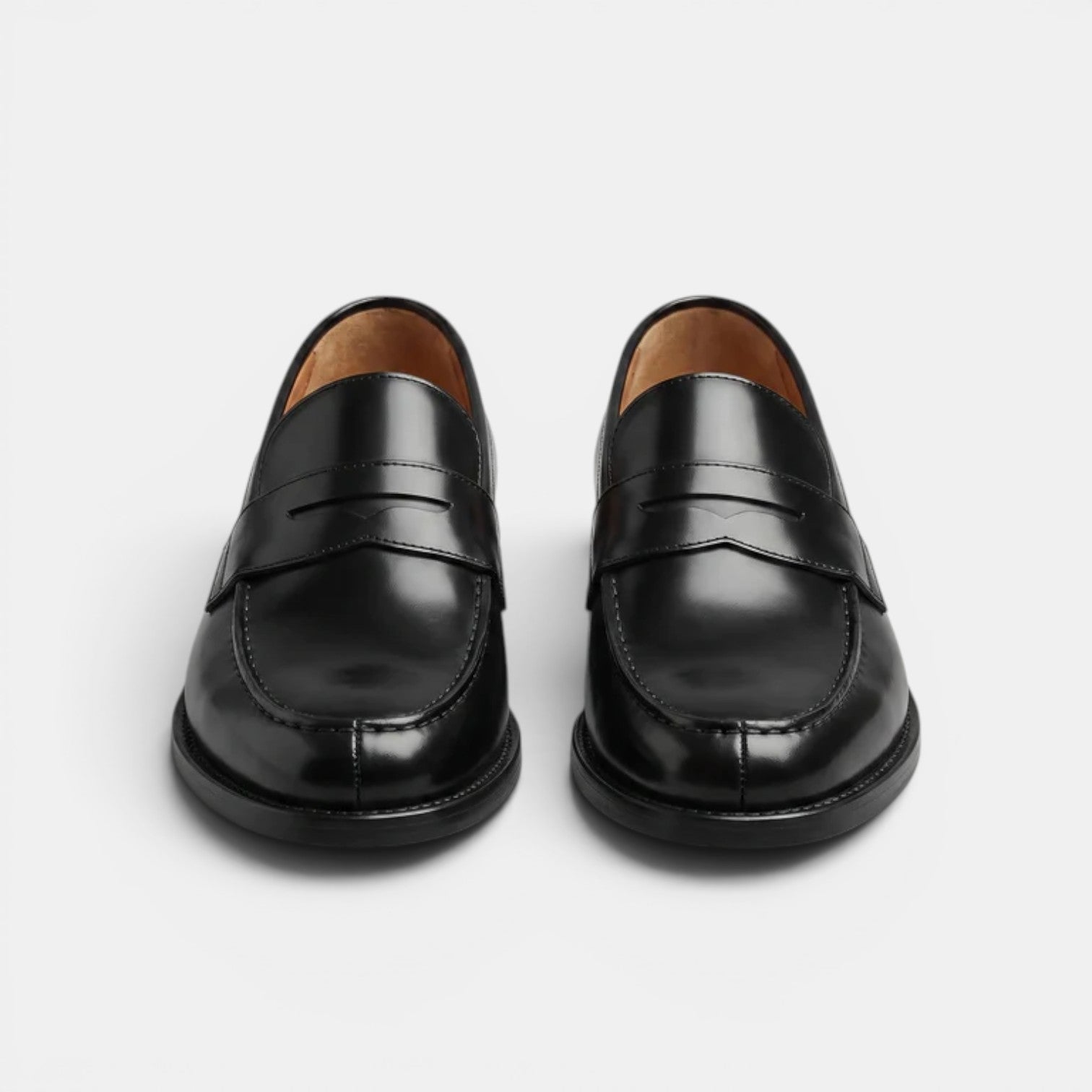 Pair of black loafers on a light gray background