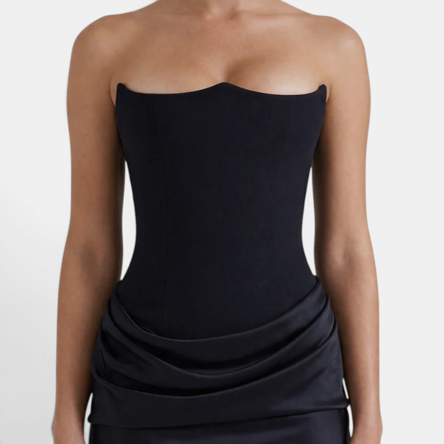 Close-up of a strapless navy corset bodice with elegant draped skirt detailing.