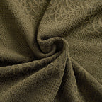 Close-up of olive green textured knit fabric, highlighting the intricate woven pattern and soft drape.