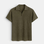Olive green short-sleeve textured knit polo shirt with an open collar, displayed against a light gray background.