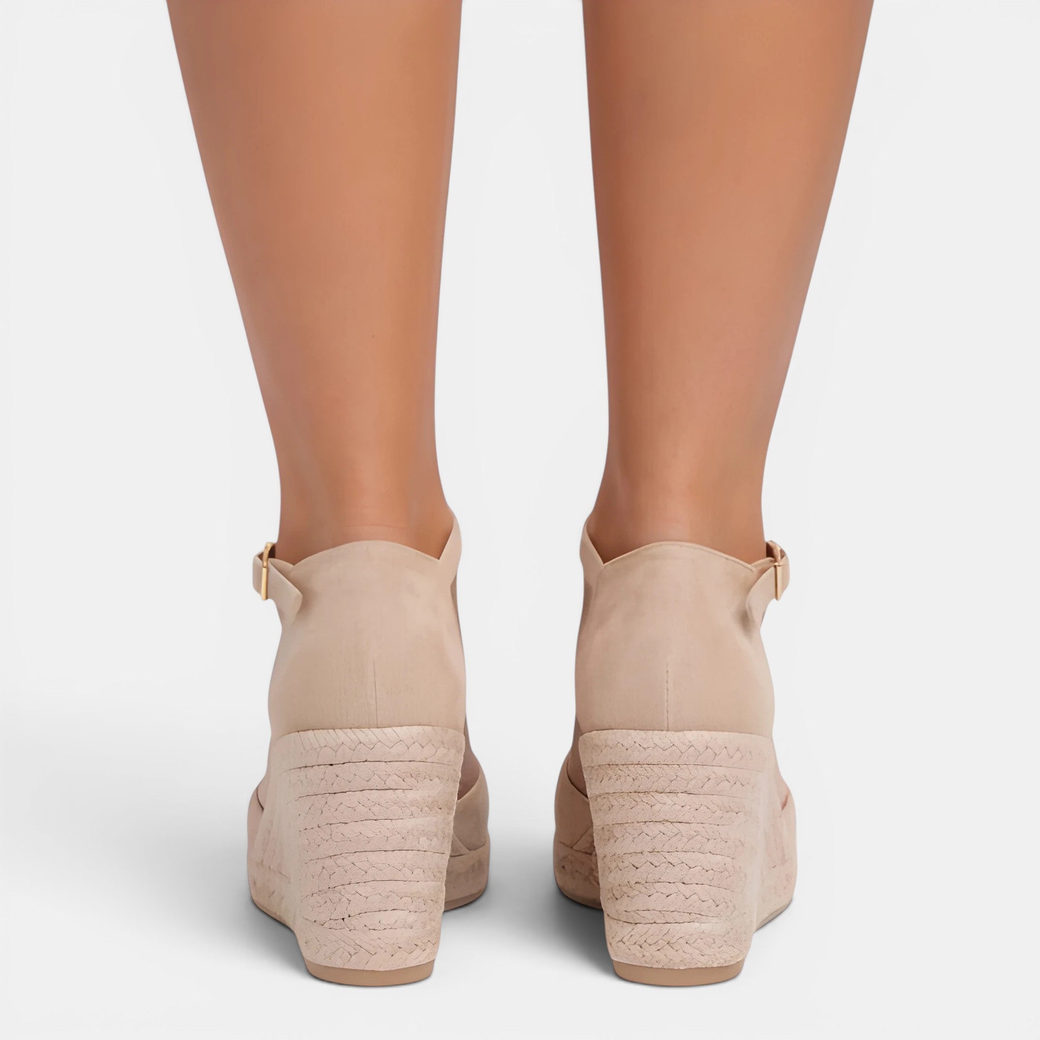Beige wedge sandals on a white background