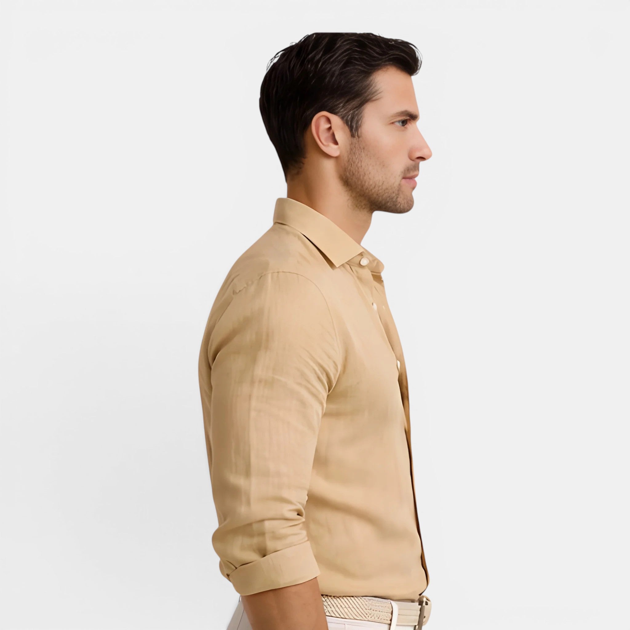 Man wearing a beige shirt against a light gray background