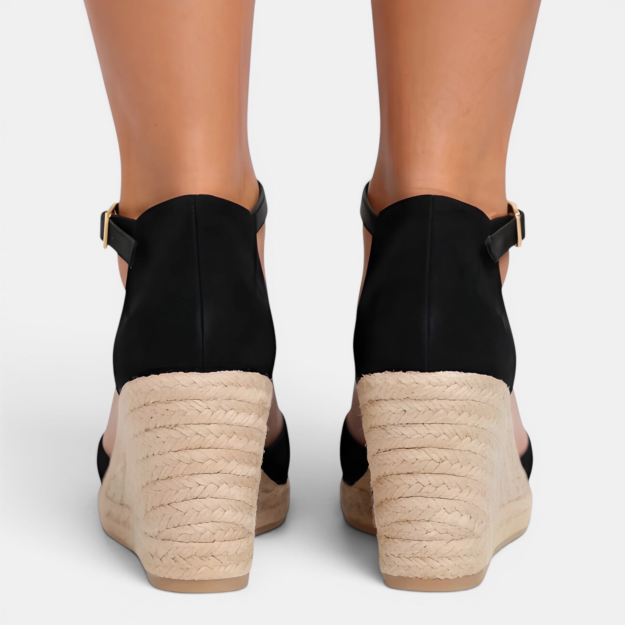 Black wedge sandals with beige soles on a white background