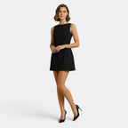 Woman wearing a black dress on a white background