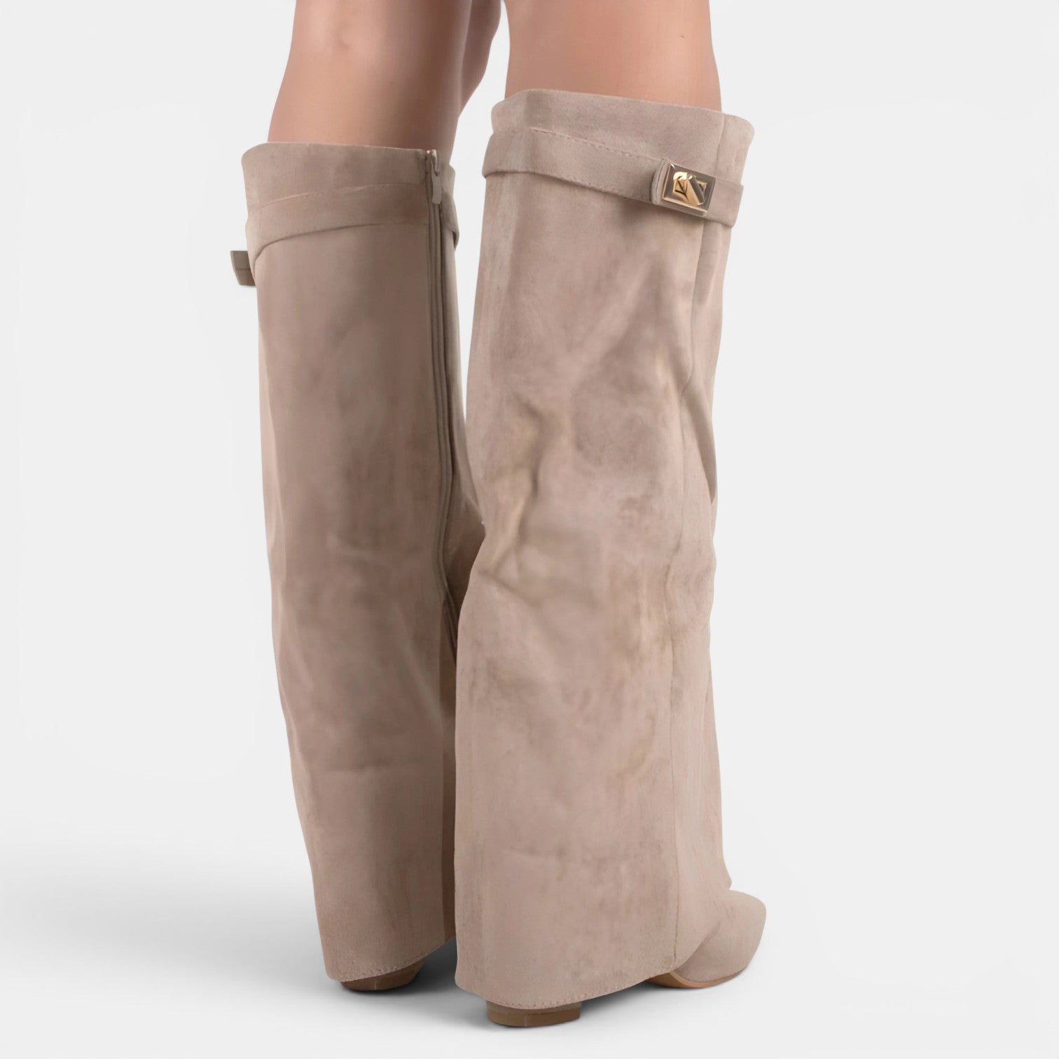 Beige knee-high boots with a buckle on a white background