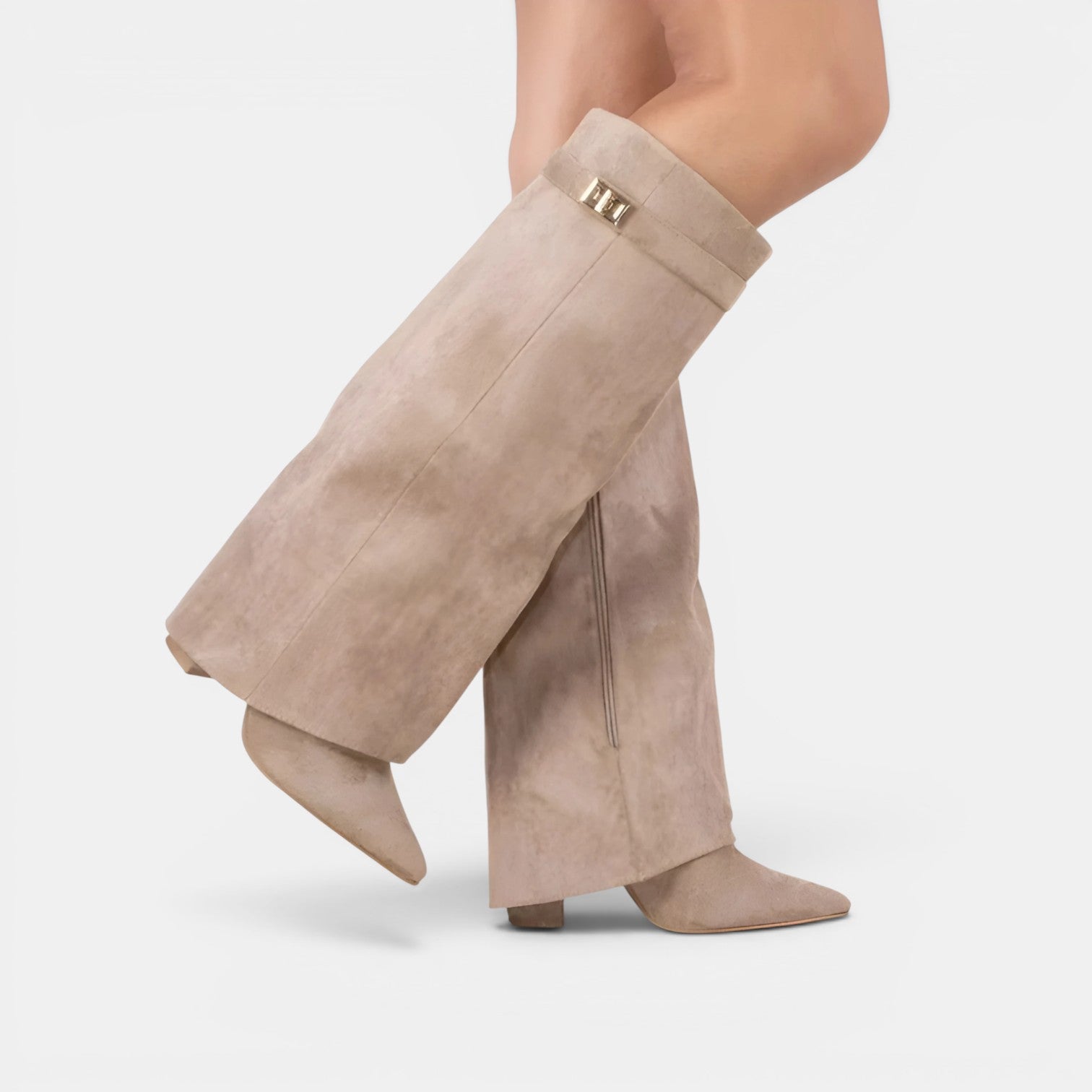 Beige suede booties worn with wide-leg pants on a white background