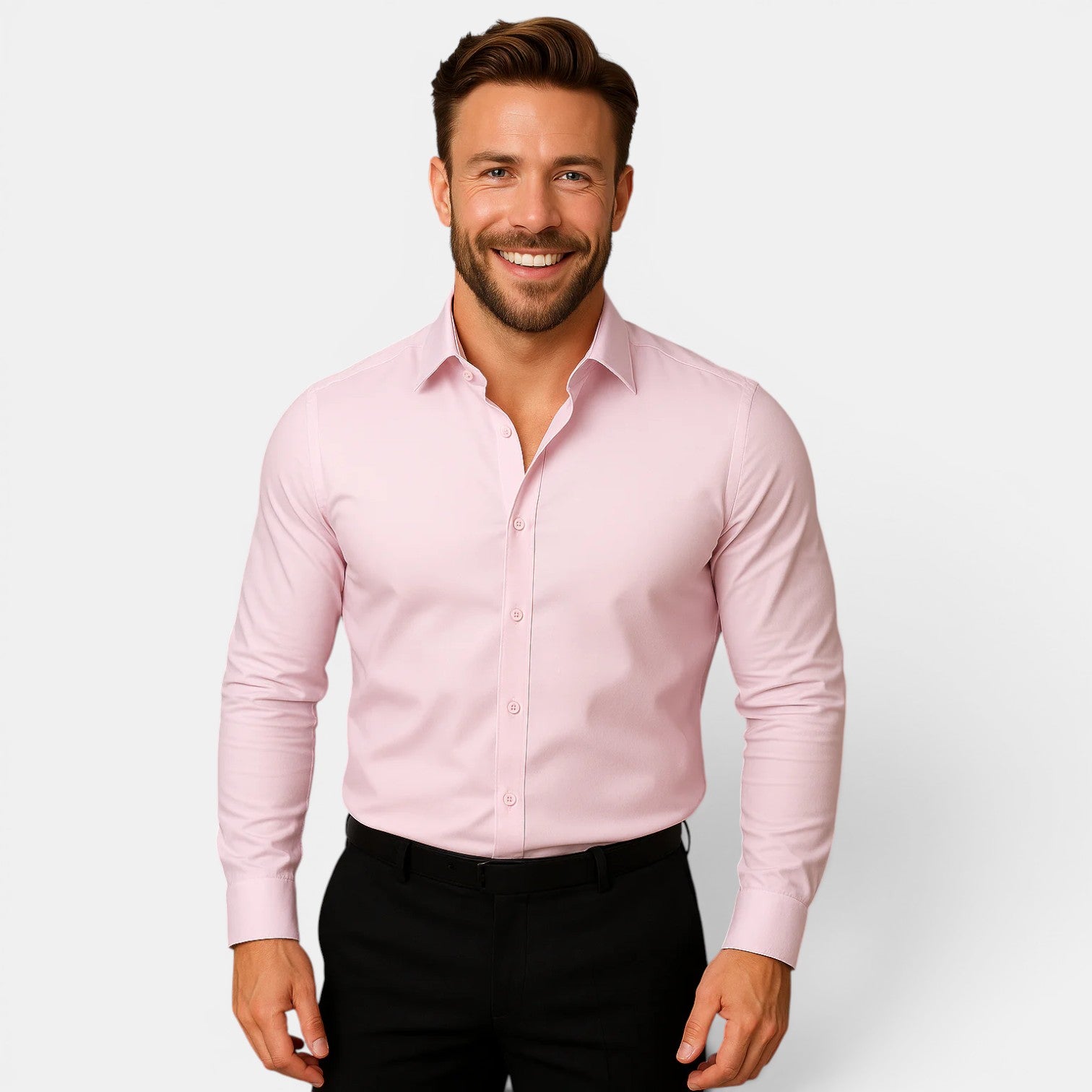 Man wearing a light pink dress shirt and black pants on a white background