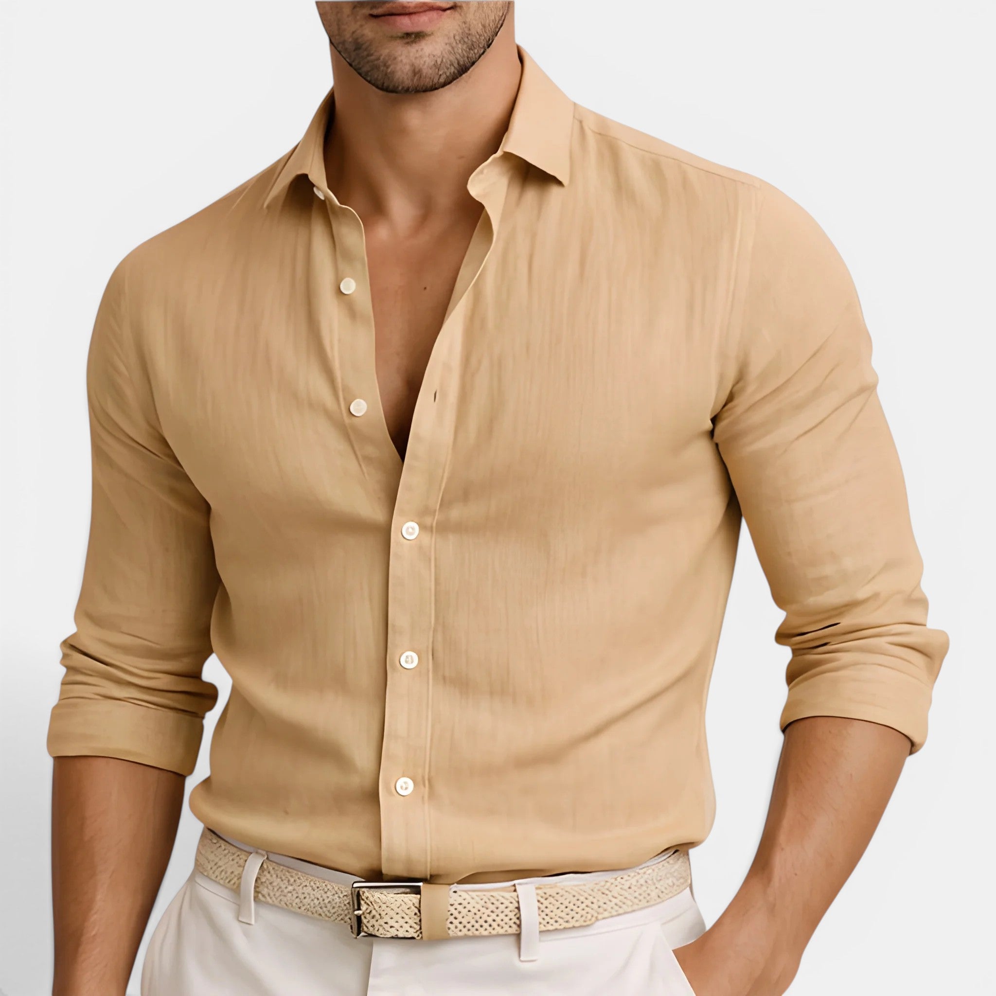 Man wearing a beige button-up shirt with rolled-up sleeves on a white background
