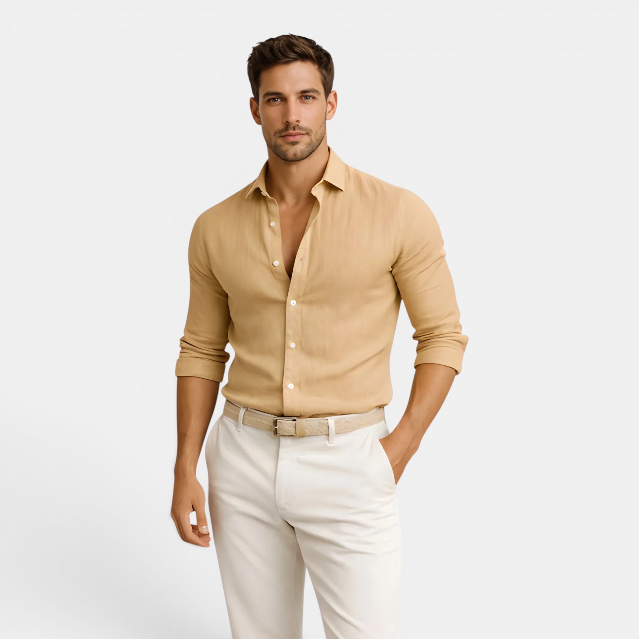 Man wearing a beige shirt and white pants on a light gray background