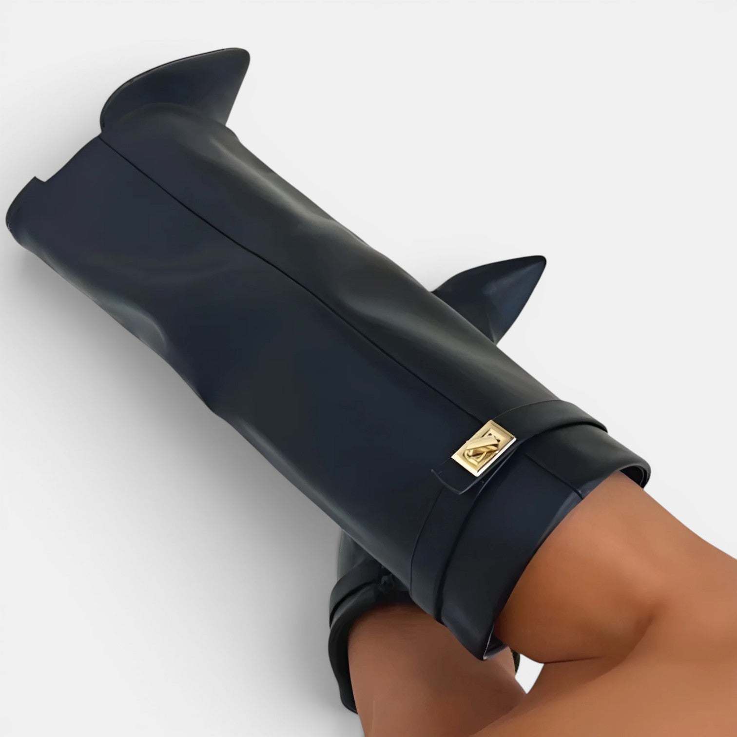 Black high-heeled shoe with a gold brand logo on a white background
