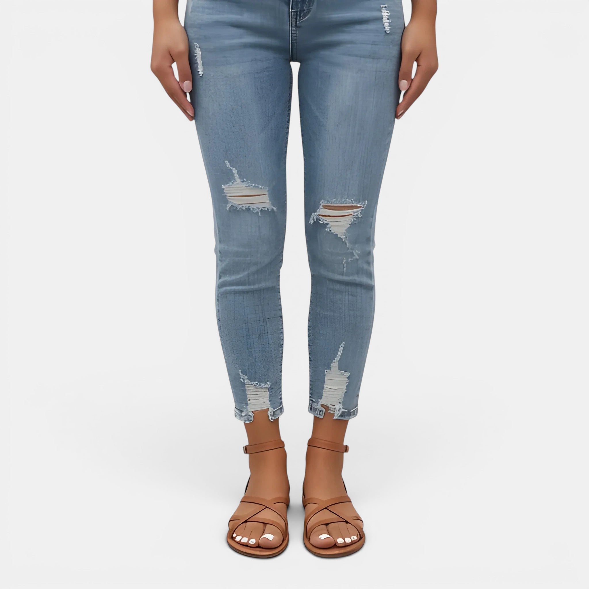 Light blue distressed jeans worn by a person on a white background