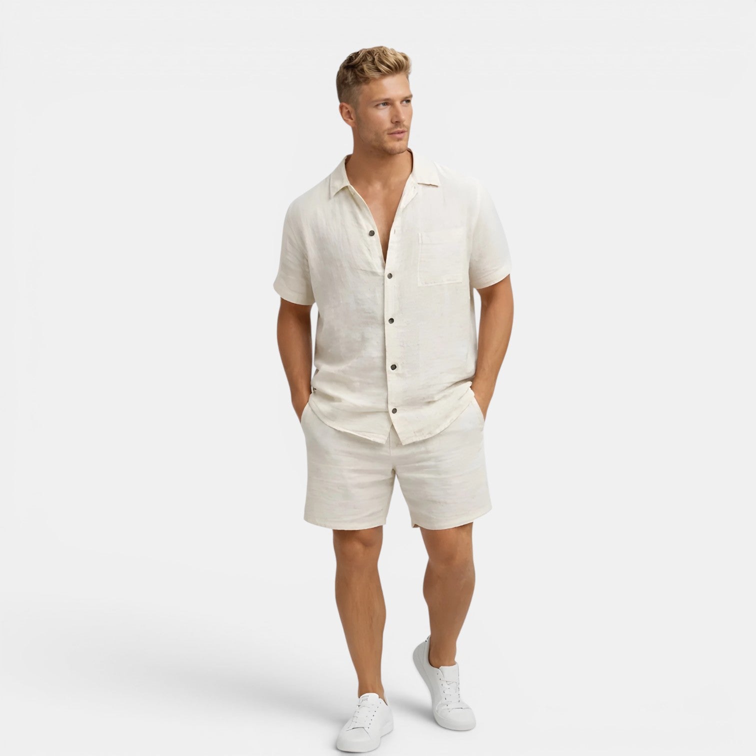 Man wearing a white linen shirt and shorts set on a white background
